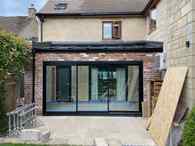 black aluminium tripe track patio doors + Ultraframe leanto roof 240724001.jpg